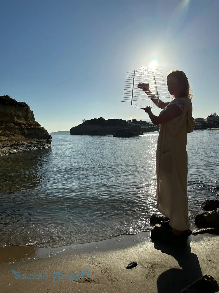 
                    
                      Natalia holdind Celtic Moon D Sacred Forest Crystal Harp at the seashore
                    
                  