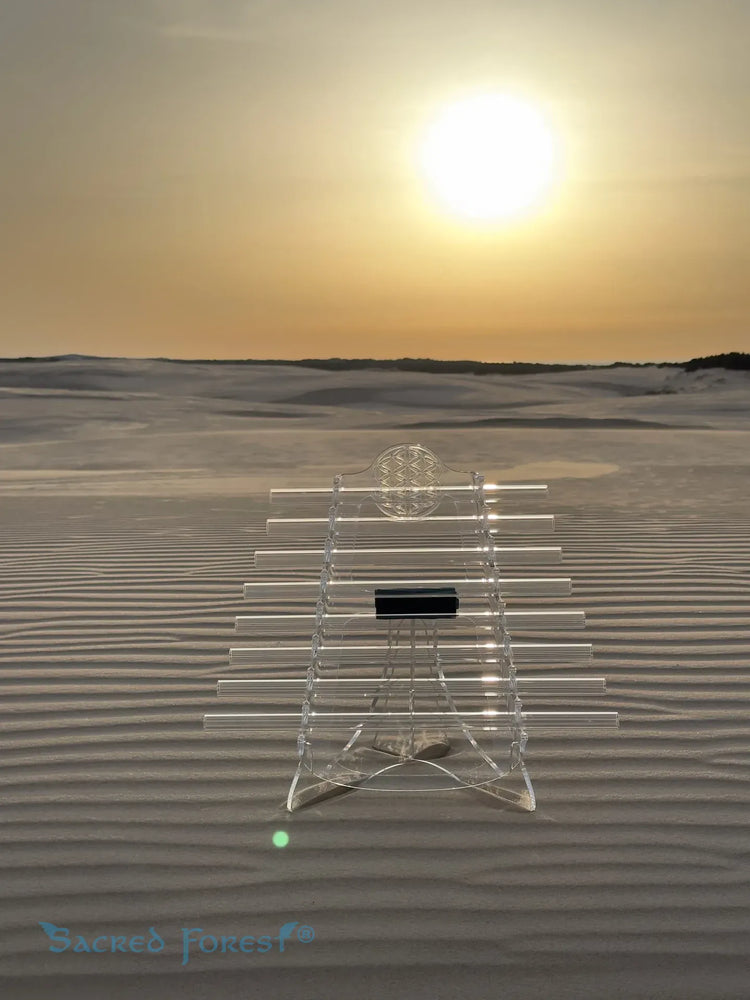 
                    
                      Sun D Sacred Forest Crystal Harp on stand in natural dune landscape with the sun
                    
                  