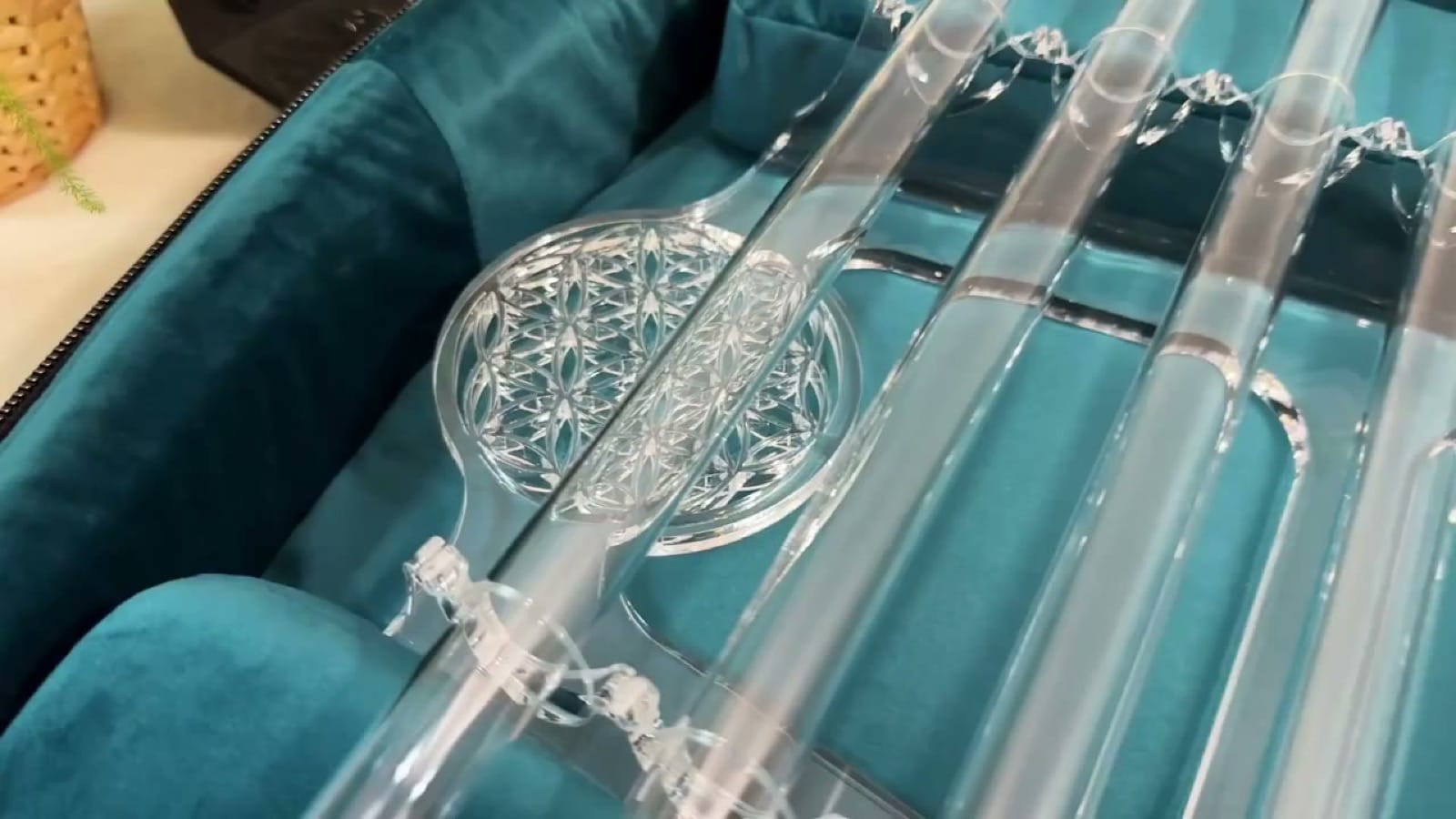 Crystal harp quartz tubes resting in a velvet-lined Sacred Forest backpack