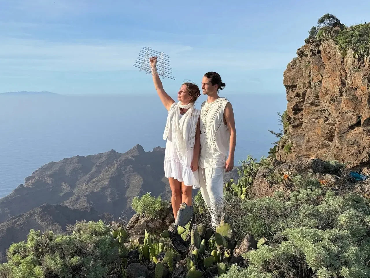 Natalia and Sever holding a Sacred Forest Crystal Harp outdoors